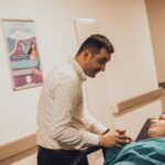 Man comforting a woman in a hospital, showcasing love and support.