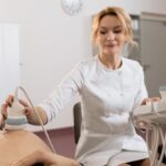 Healthcare professional performing ultrasound examination on pregnant woman in medical clinic.