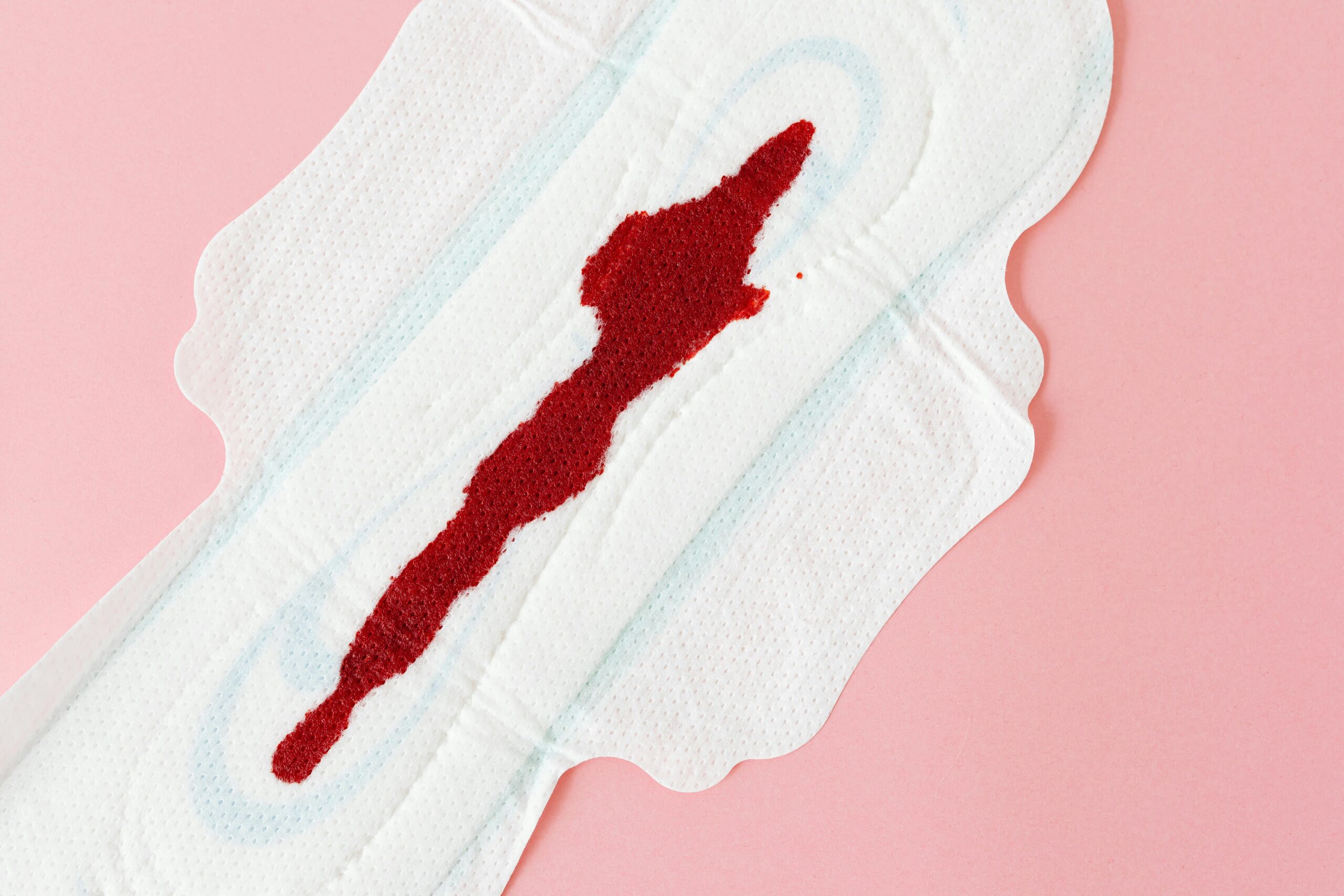 Detailed image of blood stain on a sanitary napkin symbolizing menstruation.