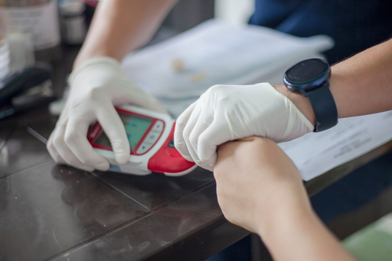 Close-up of a healthcare professional conducting a blood test with a glucometer, Ovejas, Colombia.