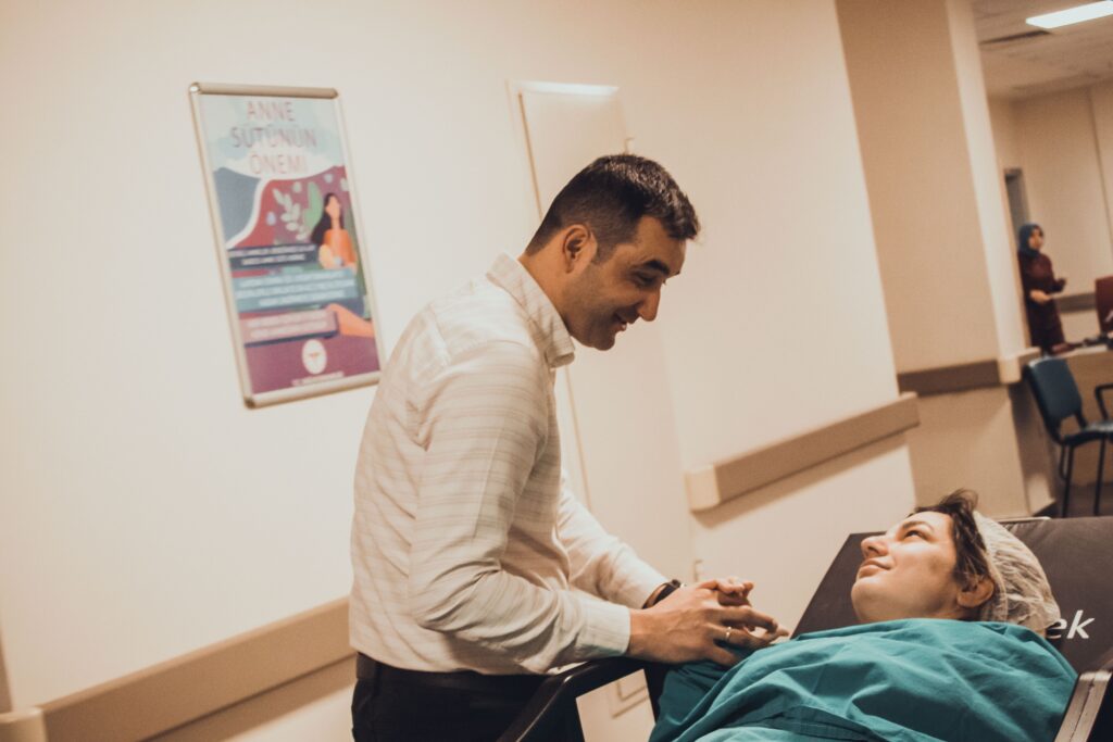 Man comforting a woman in a hospital, showcasing love and support.