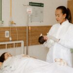 New mother and newborn in hospital room with medical staff attending.