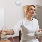A female doctor performing an ultrasound in a medical clinic.