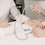 Close-up of blood pressure measurement at home highlighting healthcare equipment.