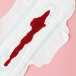 Detailed image of blood stain on a sanitary napkin symbolizing menstruation.