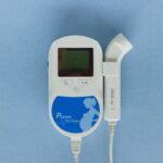High-angle view of a pocket fetal doppler device on a blue background.
