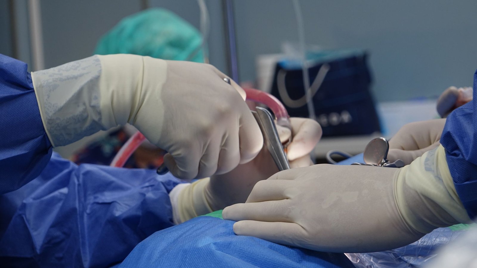 Close-up of surgeons operating in a hospital theater setting with precision.
