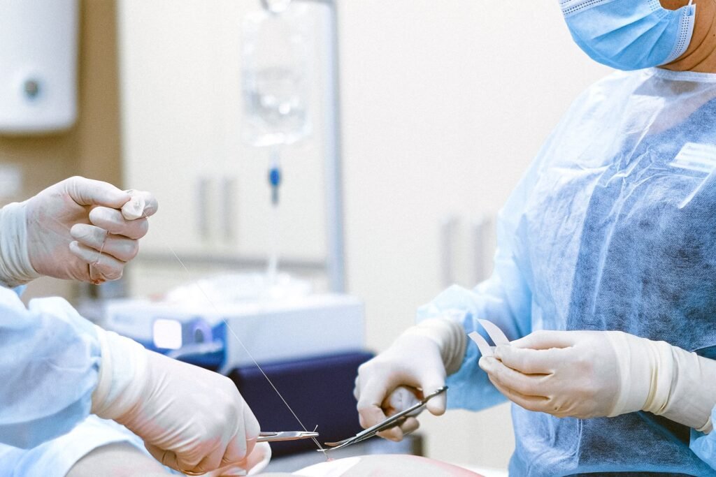 Medical professionals wearing protective equipment in an operating room